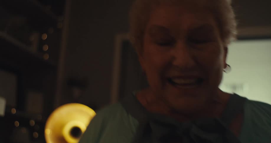 An elderly couple joyfully dances together clearly enjoying the moment