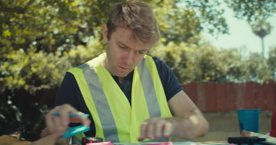 The man is putting post its on the blueprints