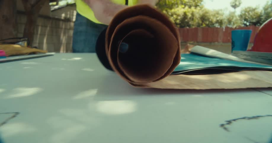 A man rolls up the blueprints