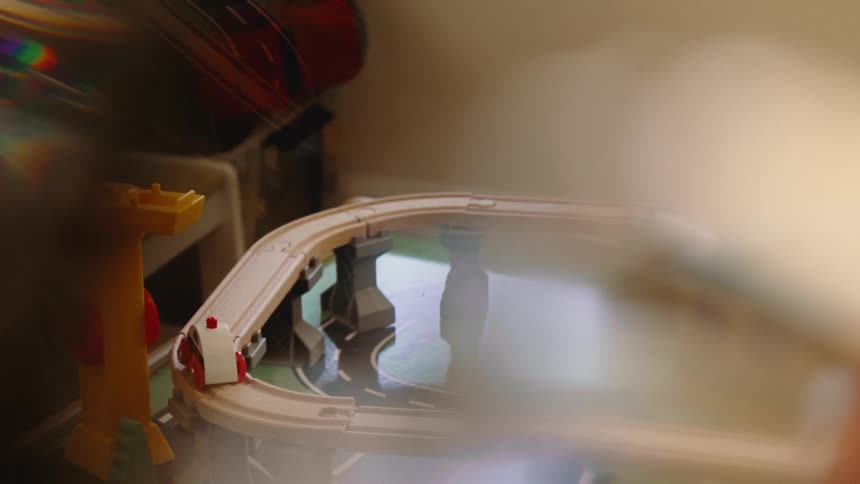 A toy track and car are in the play area