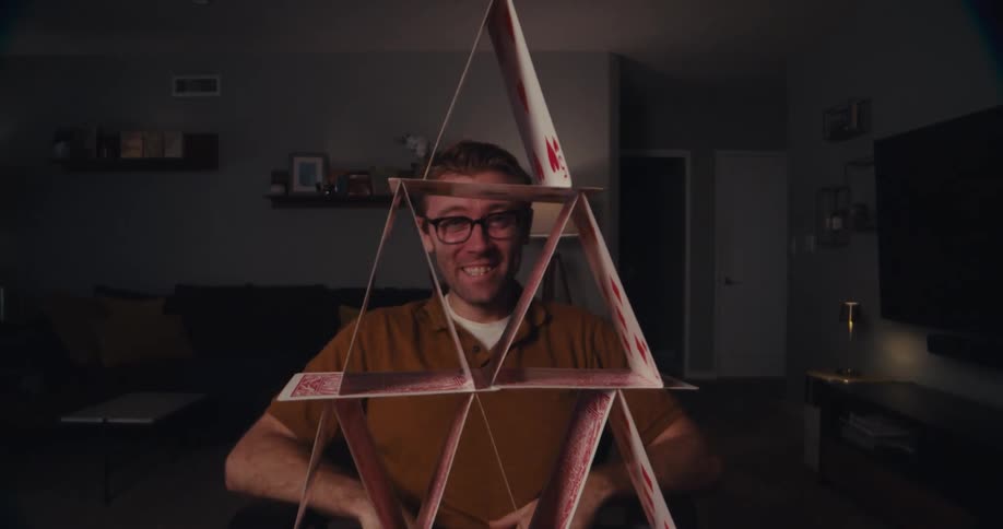 A man takes a photo of a stack of cards with his cell phone
