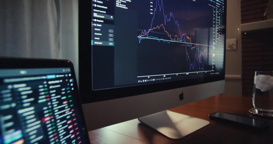 Closeup shots of computer and laptop screens showing realtime stock market fluctuations
