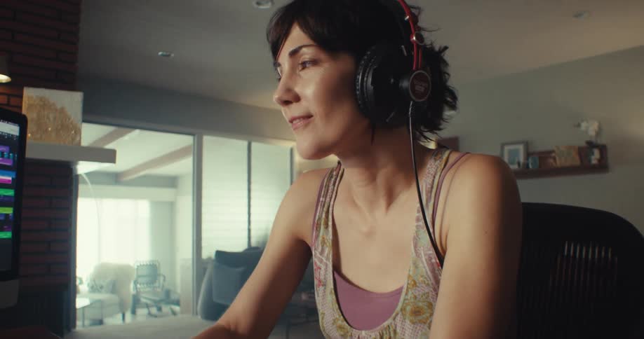 A woman djs at her computer