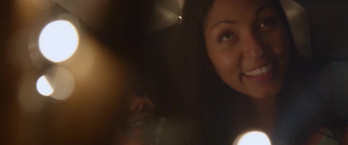Smiling woman and child look at christmas lights