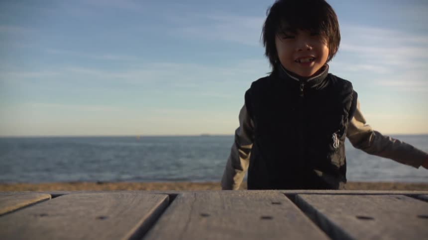 A kid playing on the beach