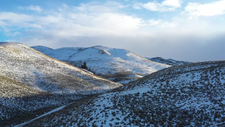A mountain range is covered in snow