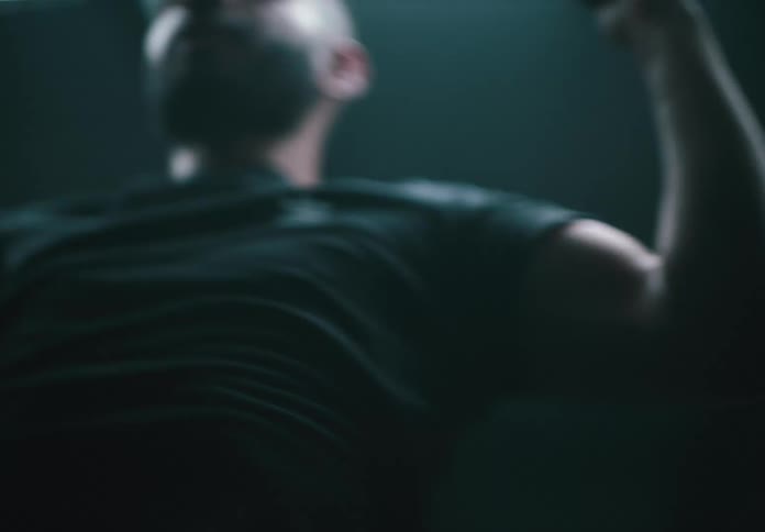 Man exercising in a gym does pull ups