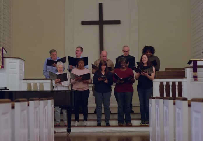 Church choir sings while standing in church