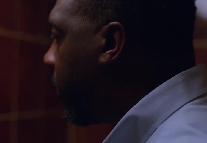 A man looking in the mirror while getting ready