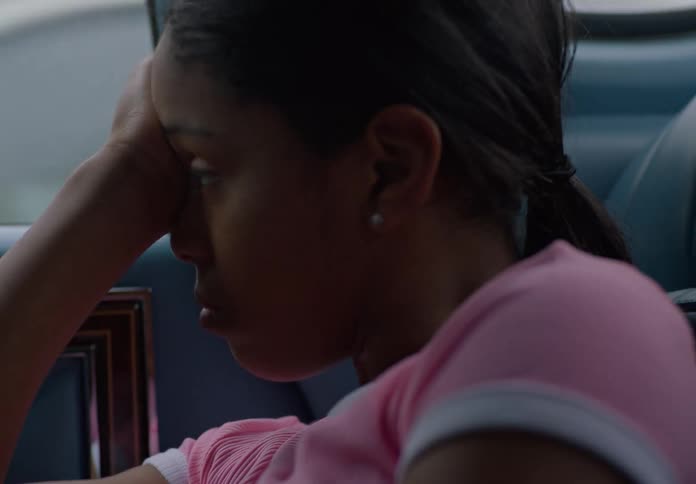 A sad girl inside a moving vehicle