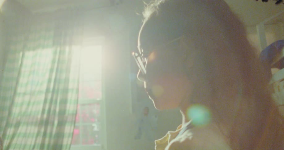 Two girls playing with their hands in a room