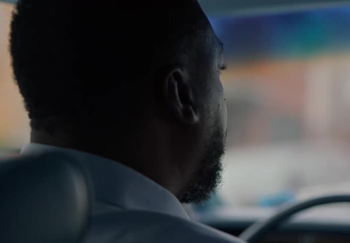 A man is talking as he drives his car