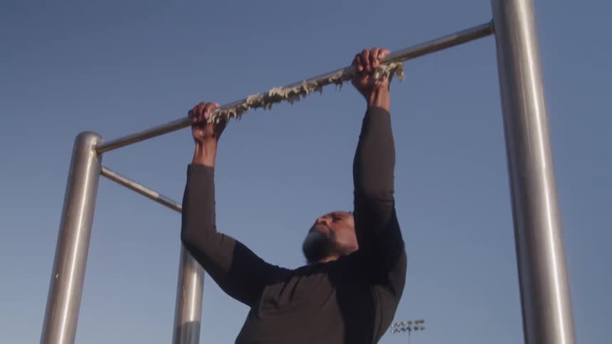 Man outdoors doing pullups