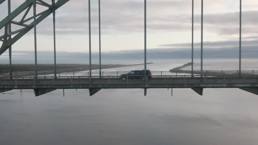 A man is jogging across the long bridge
