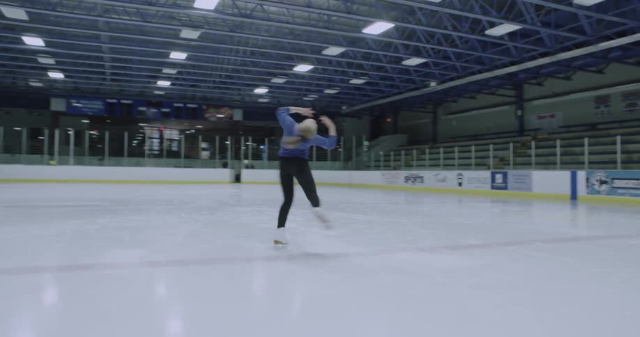 A woman is skating and doing twirls on ice