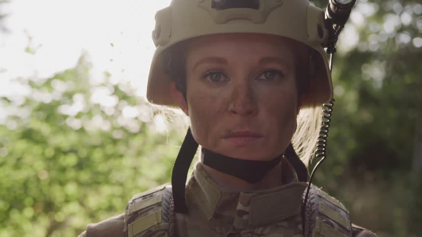 A soldier is wearing a uniform and helmet