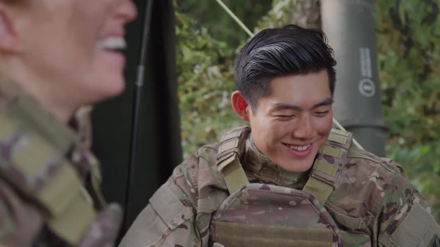 Two soldiers are laughing together