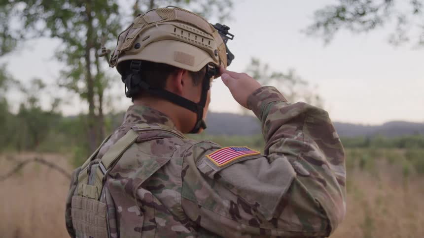 Soldier placing his hand on his forehead in a military greeting