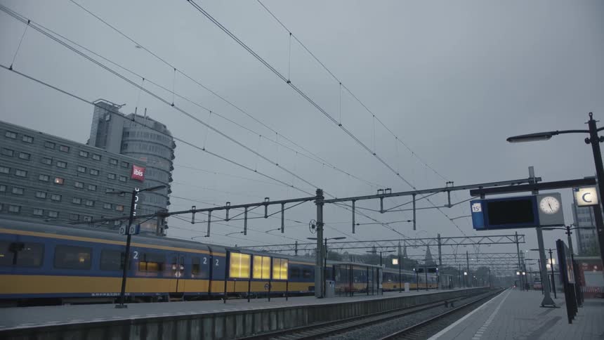 A train stopped at a station on a cloudy day