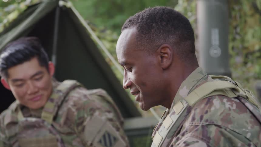 Two soldiers at a base talking