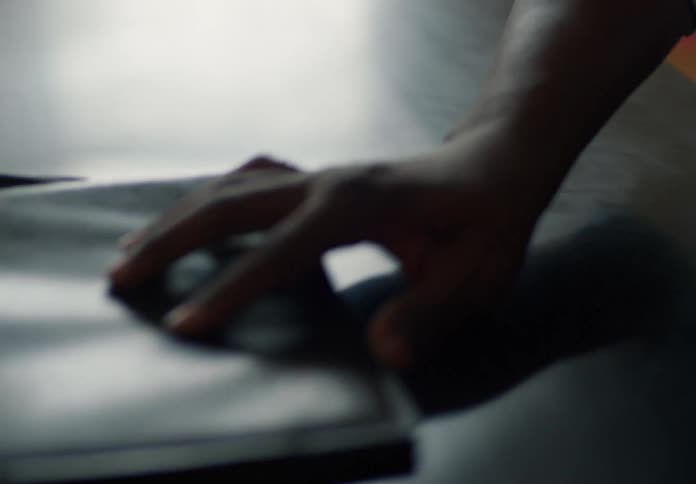 Man dragging a briefcase across a table