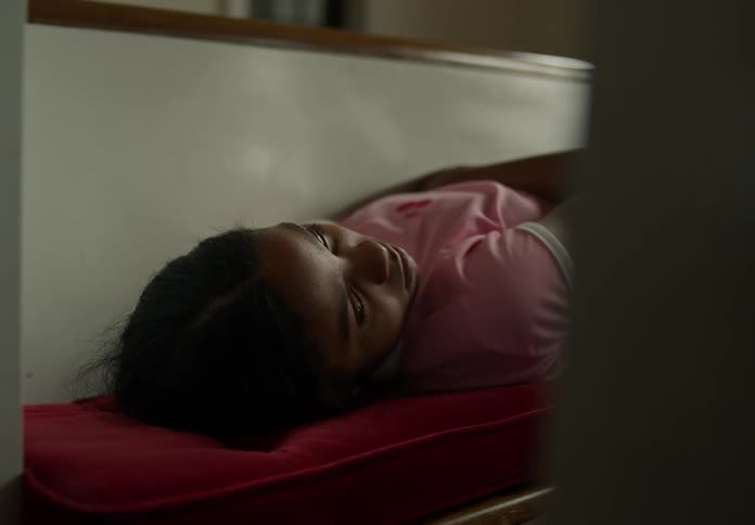 Girl lying down thoughtfully gets up