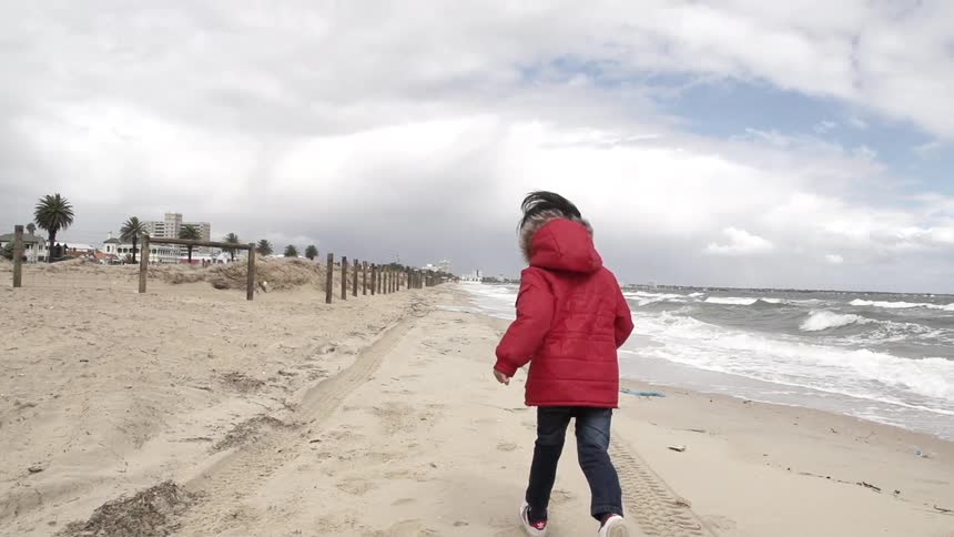A kid running on the beach