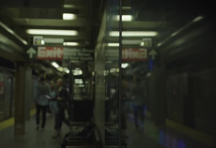 One woman heads for the train while another misses it at a busy train station