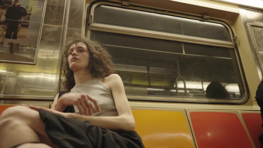 Dejected woman sitting inside a moving train