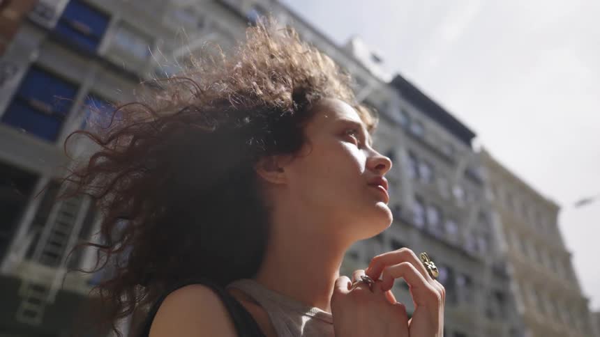 Woman outdoors in the city looking concentrated