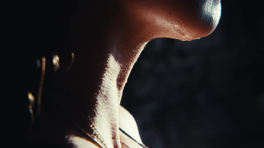 A wet woman with focus on her neck