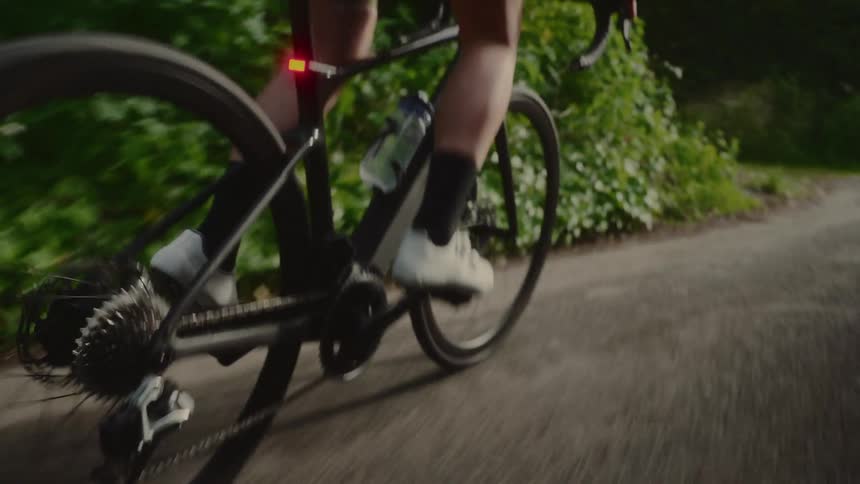 Legs of a person cycling along a trail