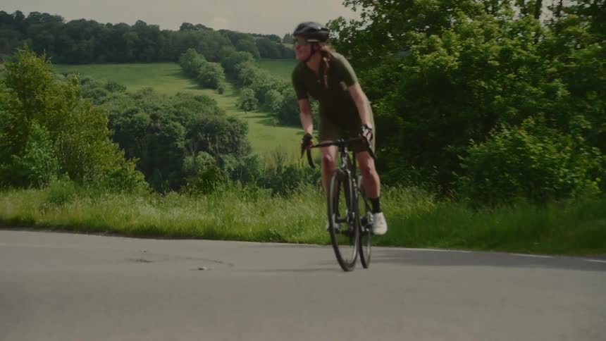 A woman riding a bicycle in a lush treefilled natural landscape