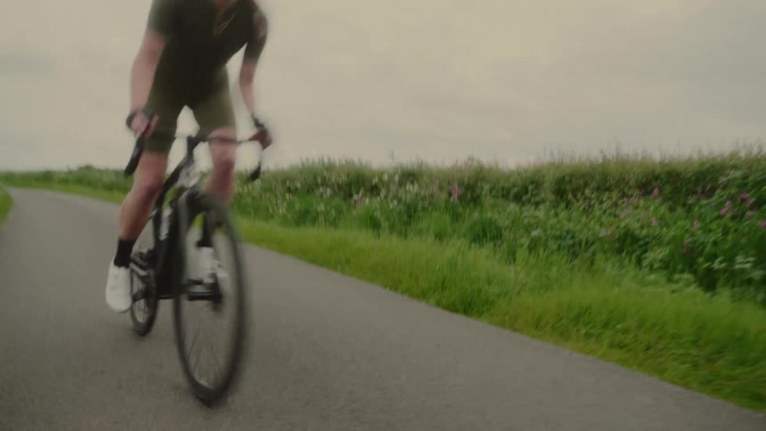 A woman is riding her bicycle on the bike path
