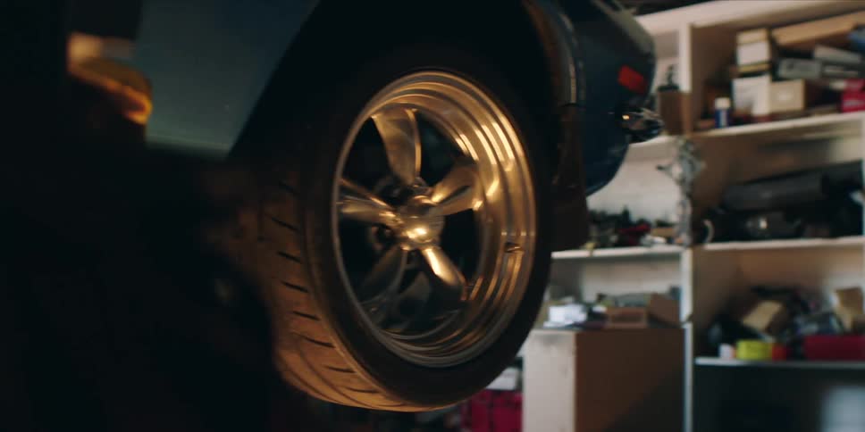 Closeup shot of a shiny car wheel in a garage setting