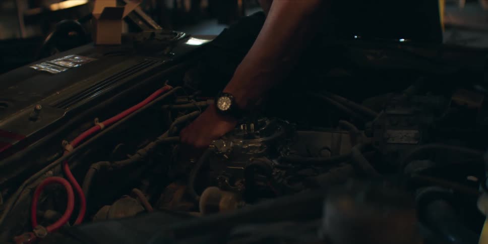 A man is working on the car engine