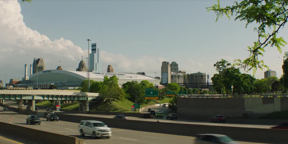 Traffic travels along highways passing the downtown skyscrapers on a cloudy day