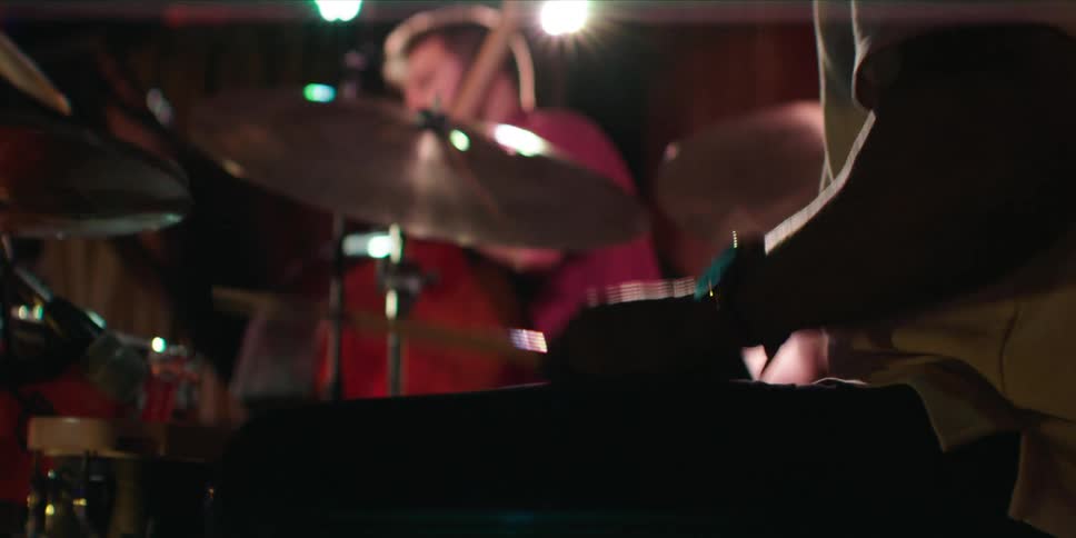 Male musicians play during a band performance