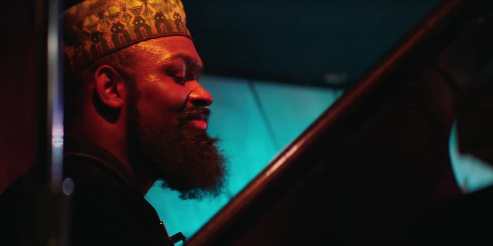 Bearded man smiles while listening to music
