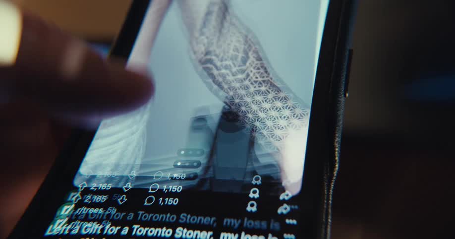 A persons finger scrolls through social media on a smartphone