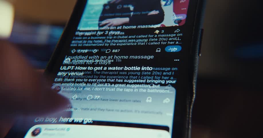 A person using a phone scrolling through their feed and reading news
