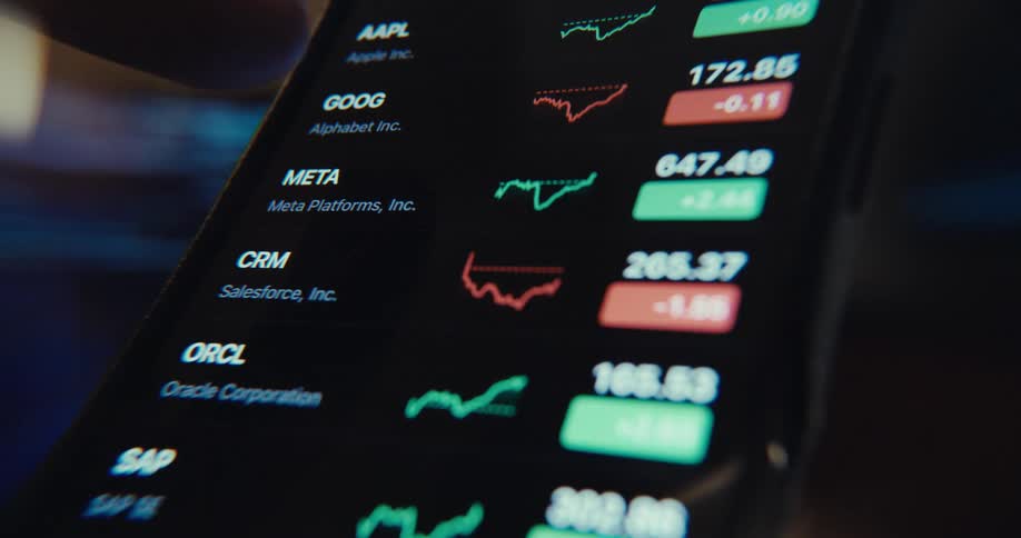 A person is interacting with a financial market app on a smartphone accessing the watchlist menu while viewing stock quotes