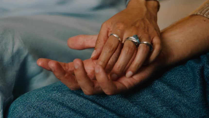Friends are sitting and holding hands