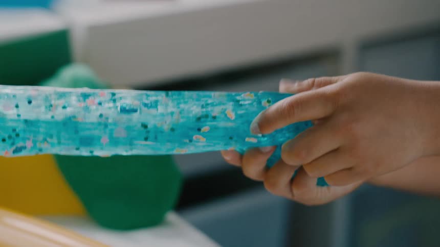 Children stretch slime together
