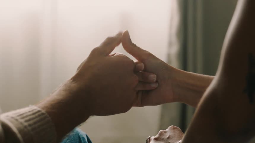 A couple play around shaking hands