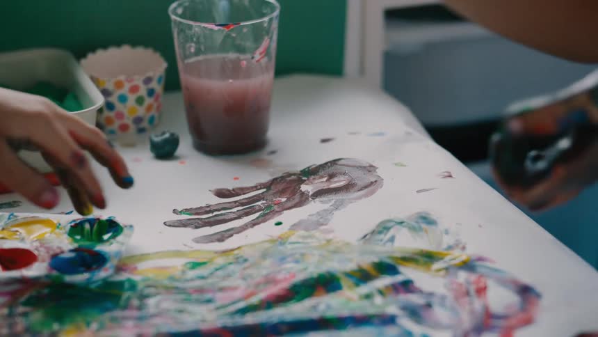 Two children are having fun painting