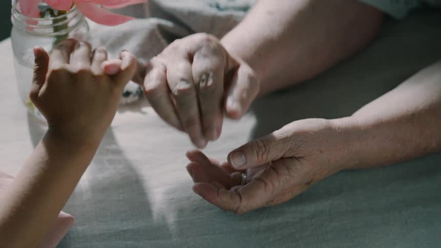 Two people shake pinkies together