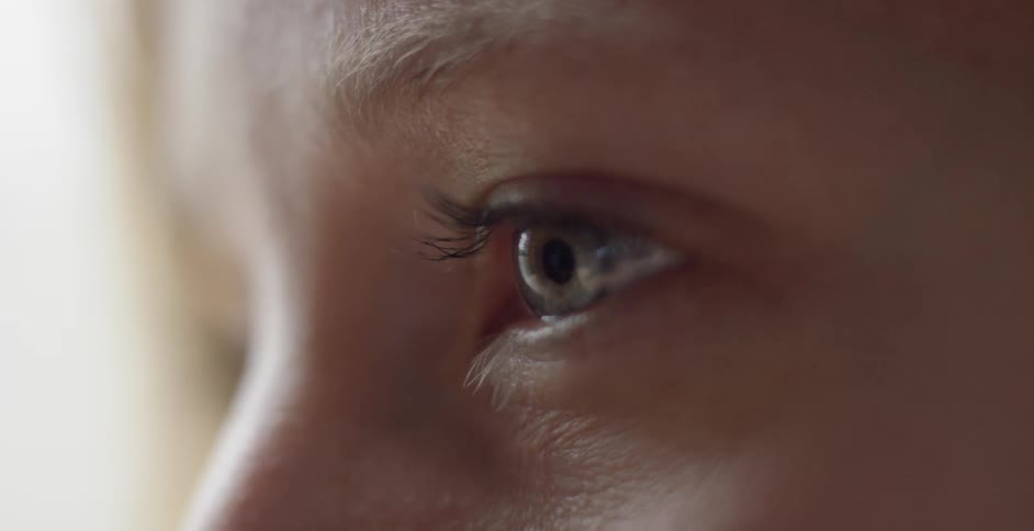 A woman slowly blinks looking forward