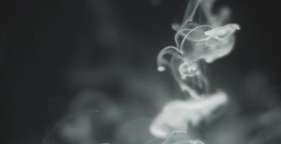 White smoke in a black room