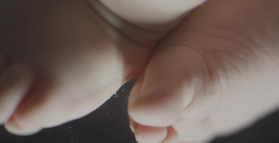 Baby feet are shown underwater